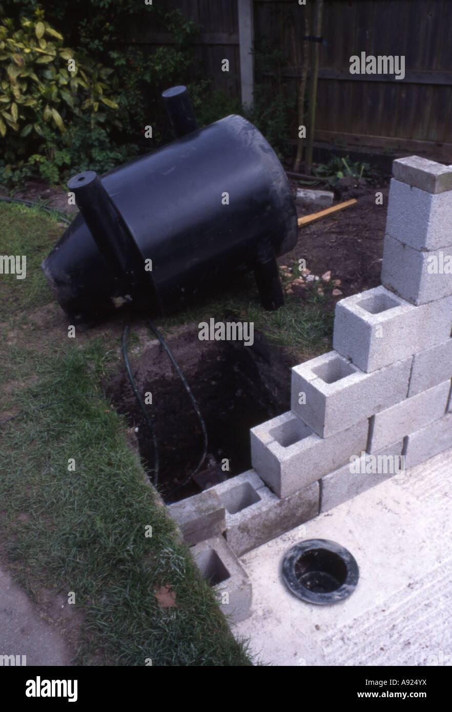 Bottom drain in new Koi pond with vortex chamber behind ready for installation UK Stock Photo