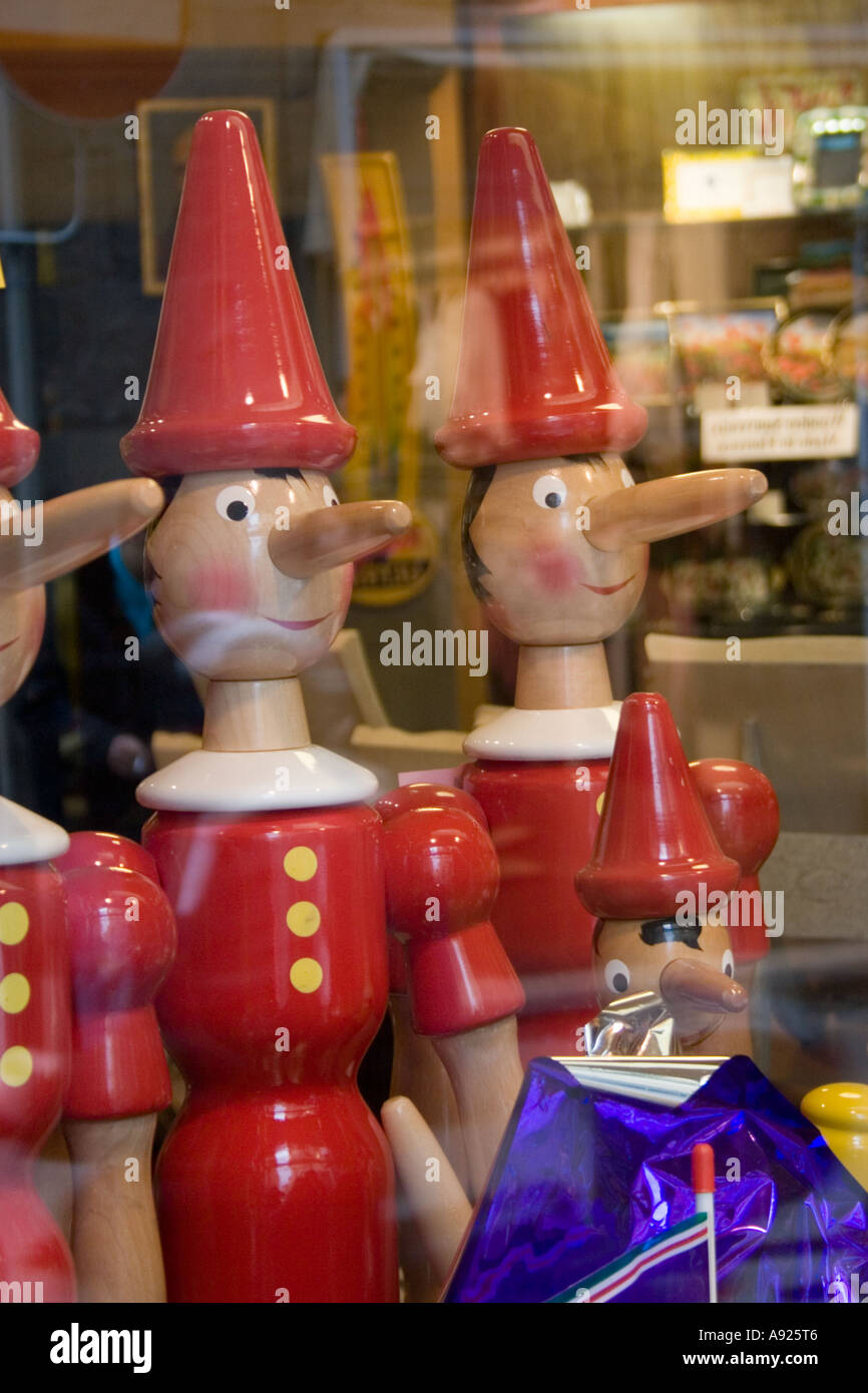 Pinocchio figures in a souvenir shop window in Florence, Italy, Europe. Stock Photo