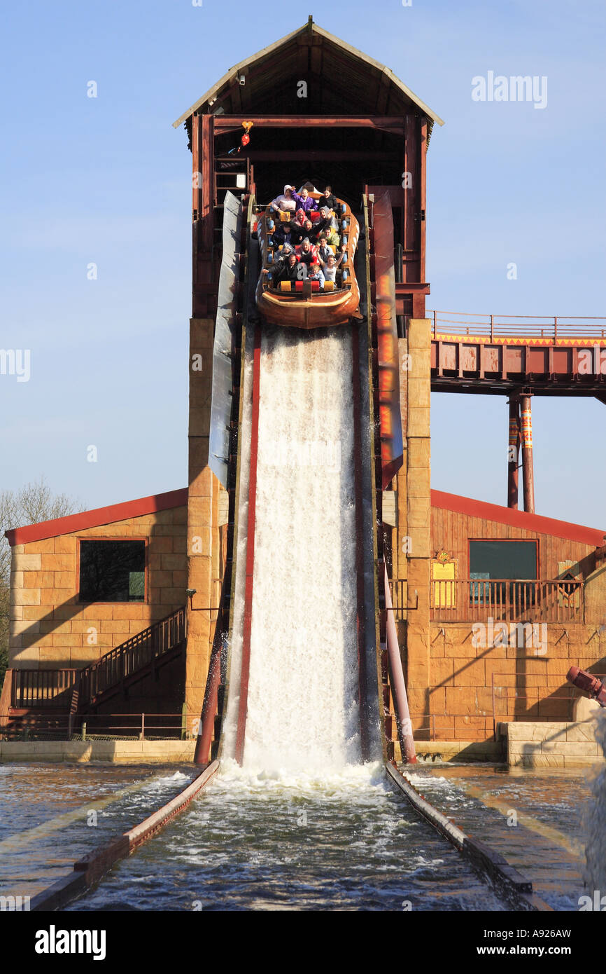 Boat full of thrillseekers plunges over the waterfall on the water ride ...