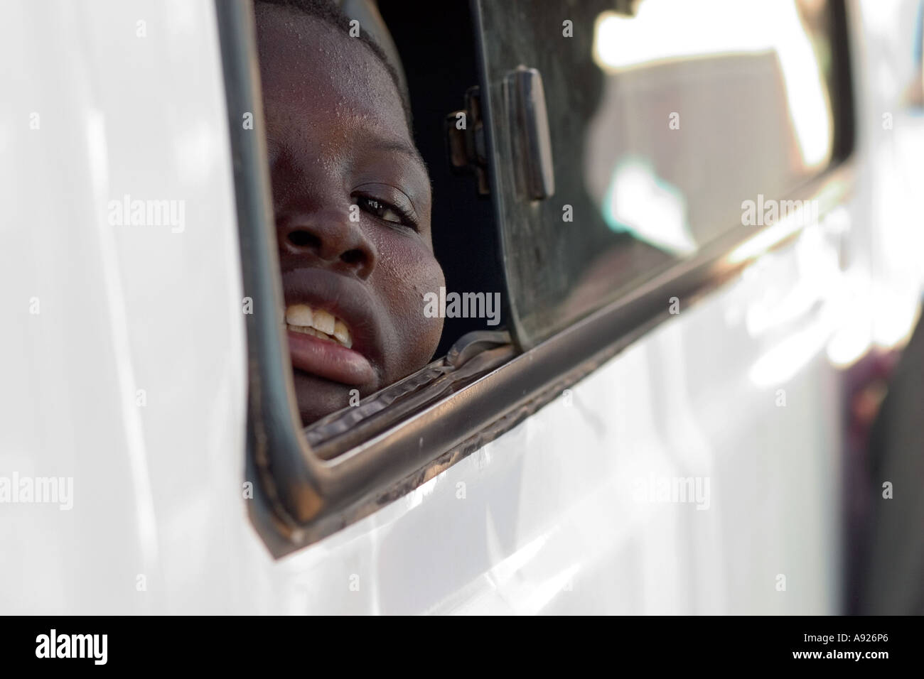 Boy peeking out car window Ghana West Africa Stock Photo