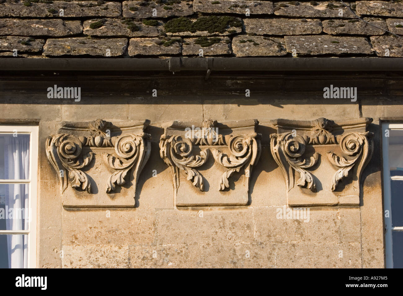 Capitals of Corinthian columns set in wall of house in Lacock Stock Photo