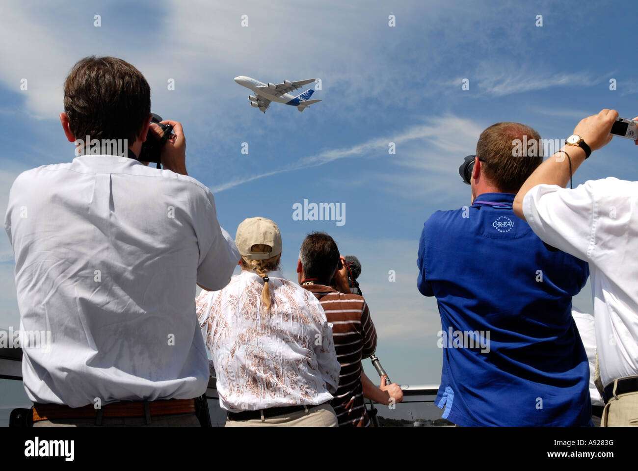 Members of the press photograph an air display featuring the Airbus A380 at the Farnborough Airshow Hampshire U K Stock Photo