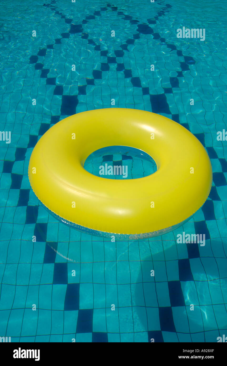 Yellow rubber ring in swimming pool Stock Photo - Alamy