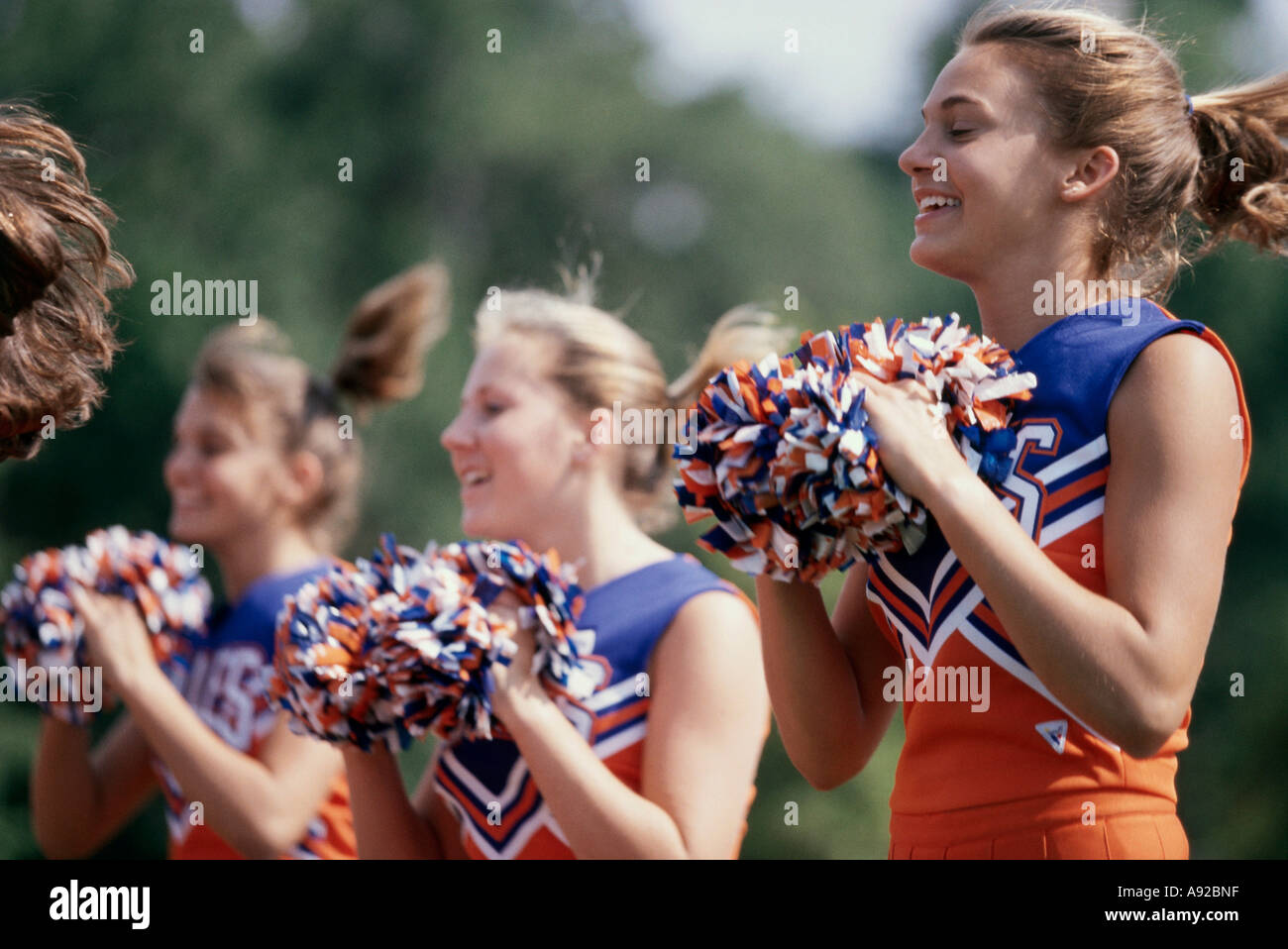 Cheerleaders In Uniform Holding Pom-Poms Stock Photo, Picture and Royalty  Free Image. Image 5428495.