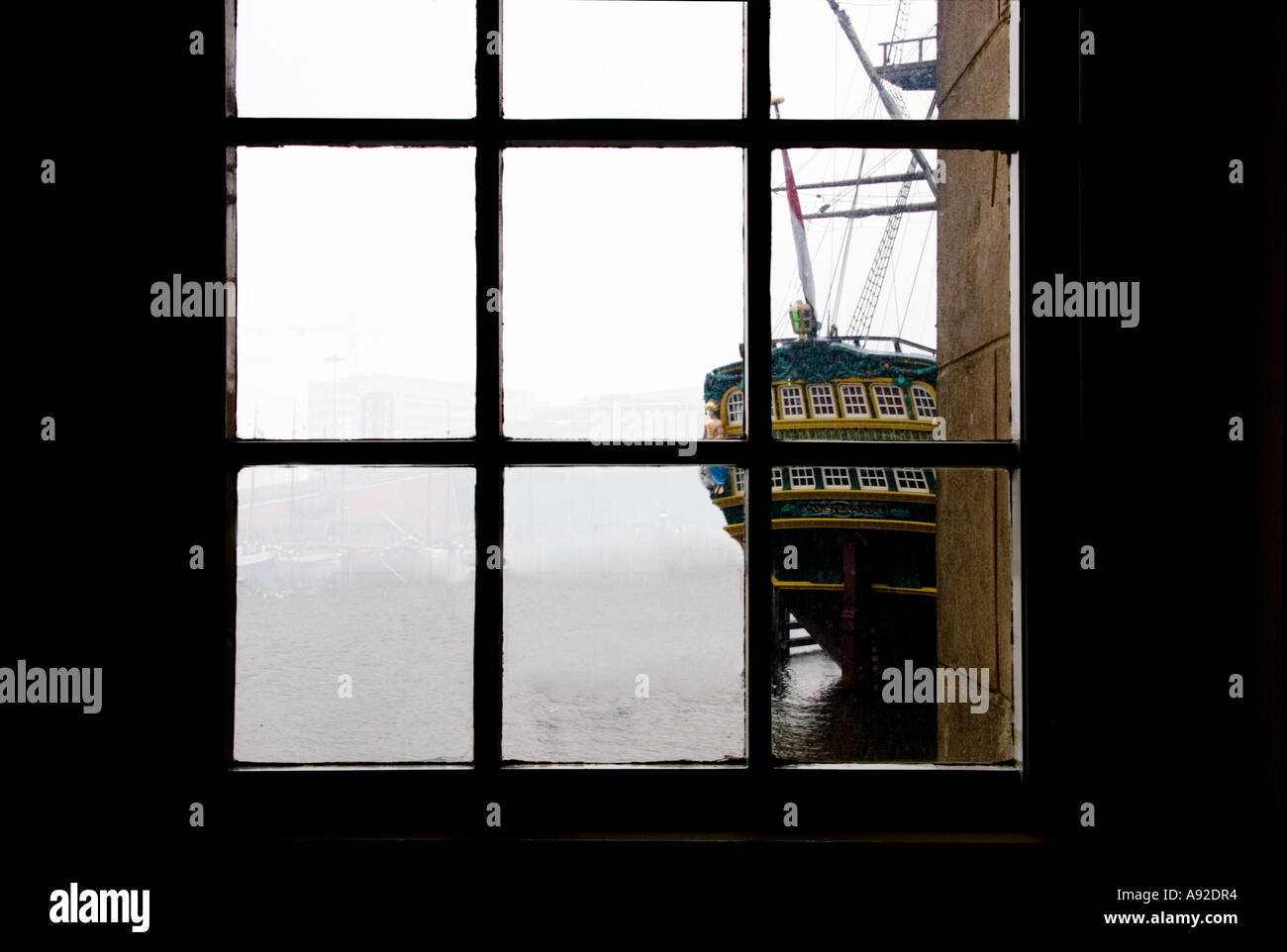 Historic sailing ship viewed from a multi paned window Stock Photo