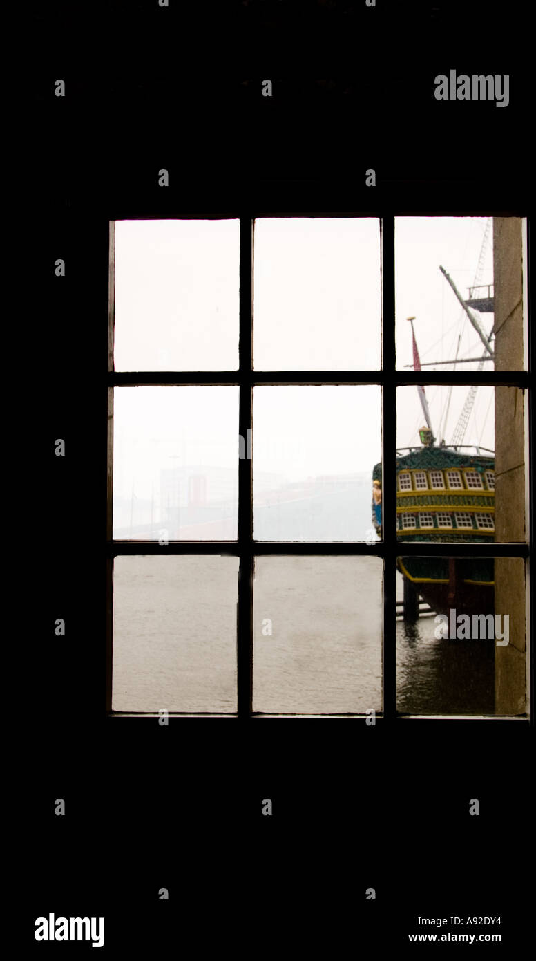 Historic sailing ship viewed from a multi paned window Stock Photo