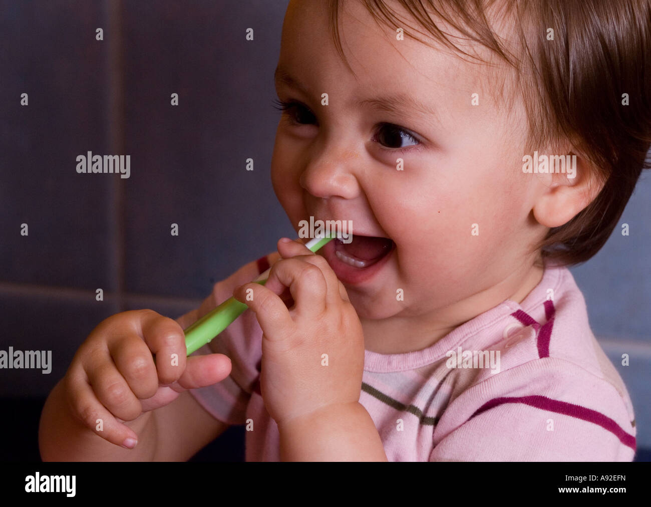 One year old girl brushes her milk teeth Stock Photo