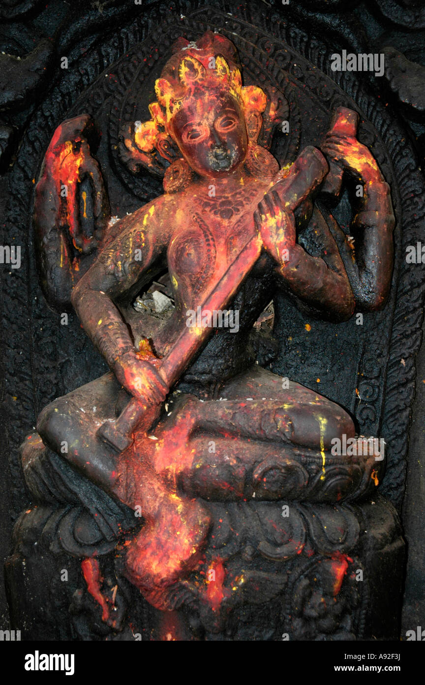 Old relief of the goddess Saraswati covered with red and yellow paint Kathmandu Nepal Stock Photo