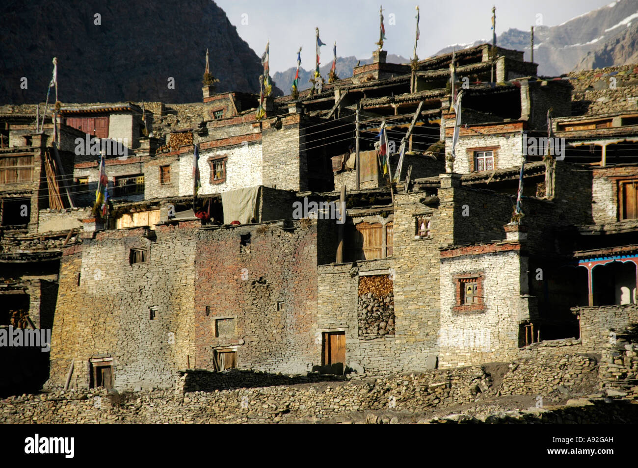 Nested houses made of stones with flat roofs and prayer flags Nar Nar-Phu Annapurna Region Nepal Stock Photo