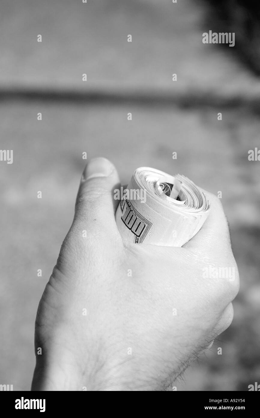 details of hand and fingers of man having bundle of one hundred american dollars currency Stock Photo