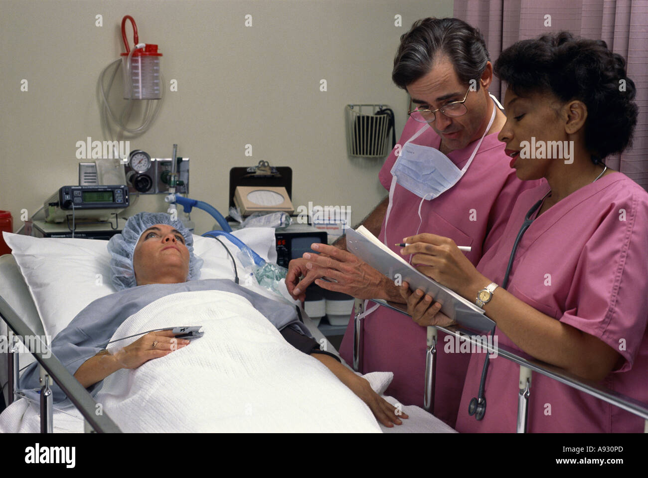 Doctor attending to a patient with a nurse Stock Photo Alamy