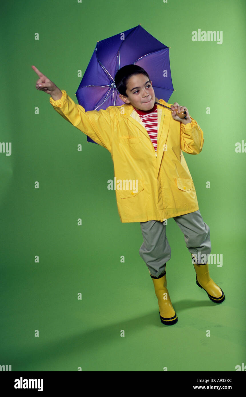 Boy wearing a raincoat and holding an umbrella Stock Photo Alamy