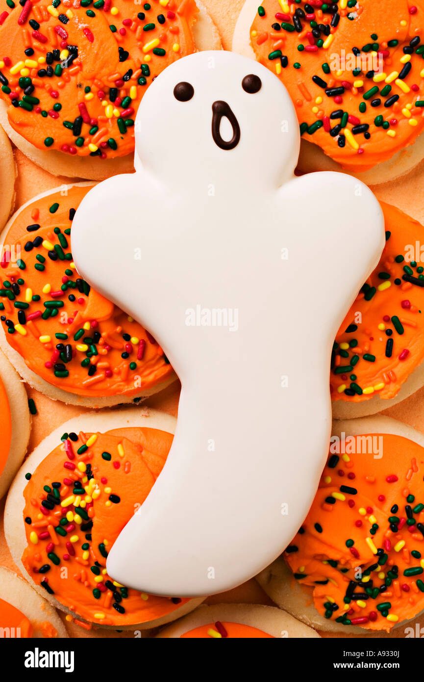 Ghost cookie on pile of frosted covered sugar cookies, humor Stock Photo