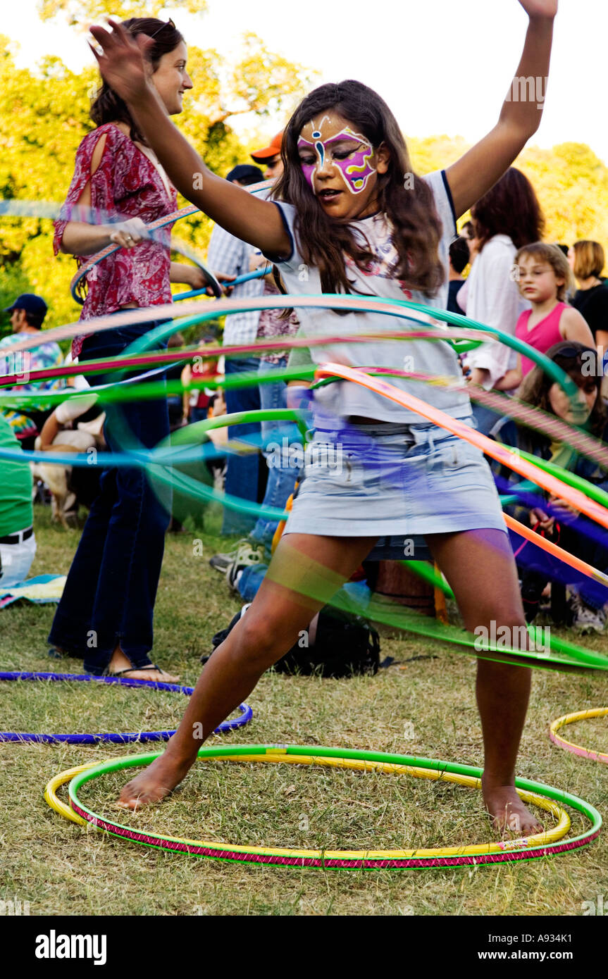 young girl with several hula hoops in Austin Texas at  Eeyore's birthday party celebration Stock Photo