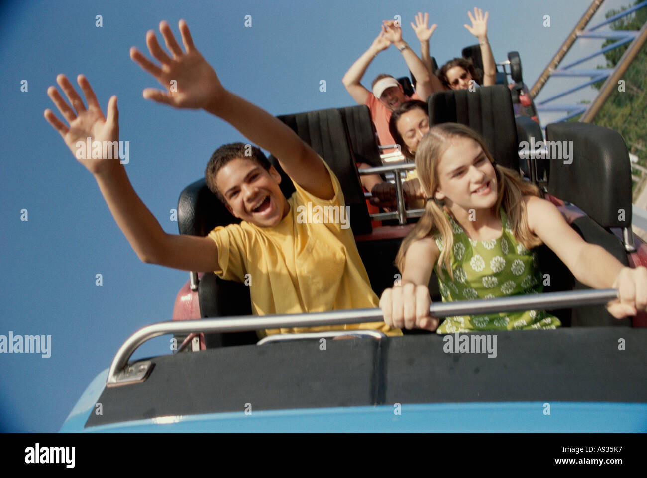 Teenage couple riding a rollercoaster Stock Photo - Alamy