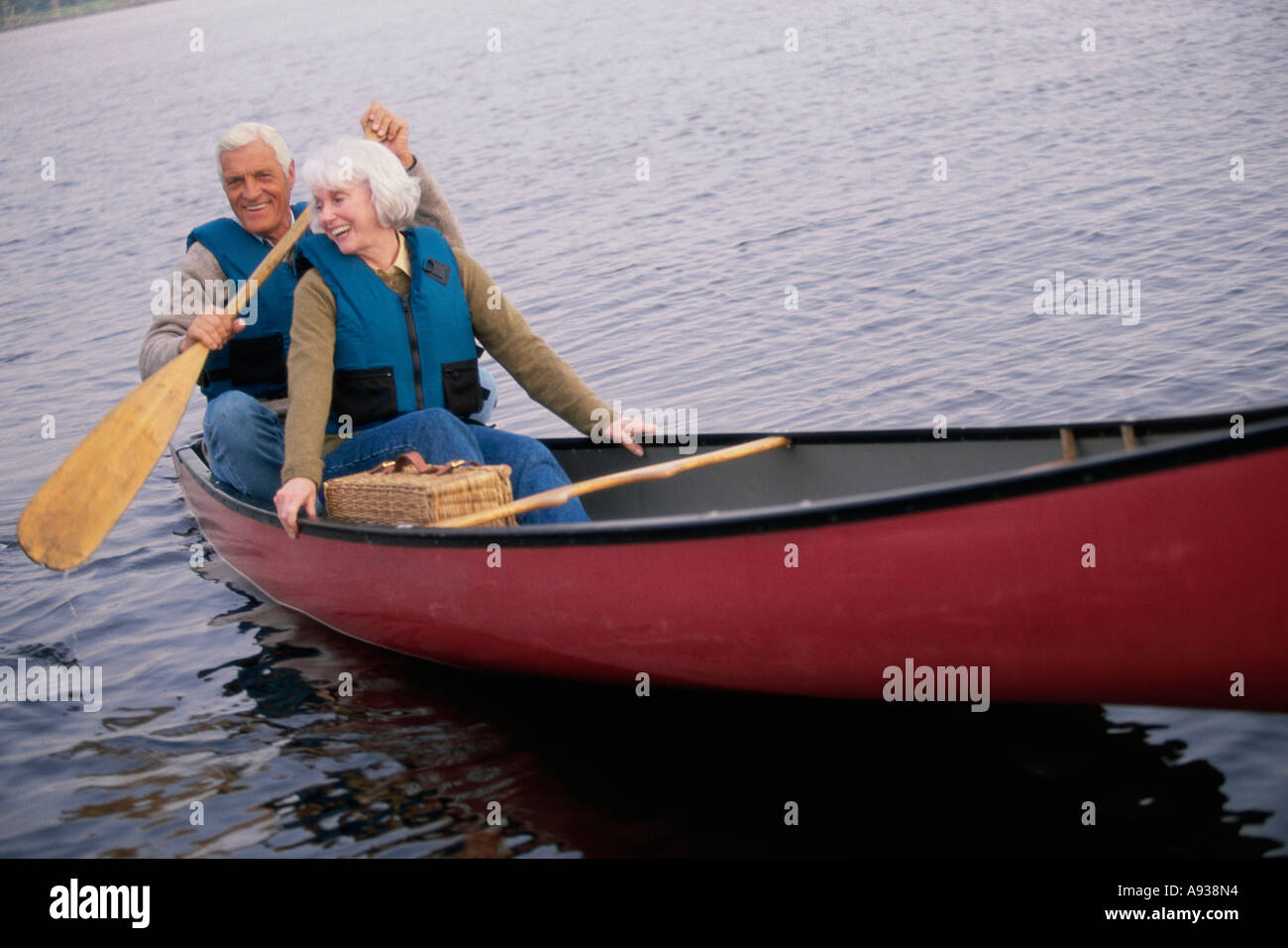 Senior couple rowing a boat Stock Photo
