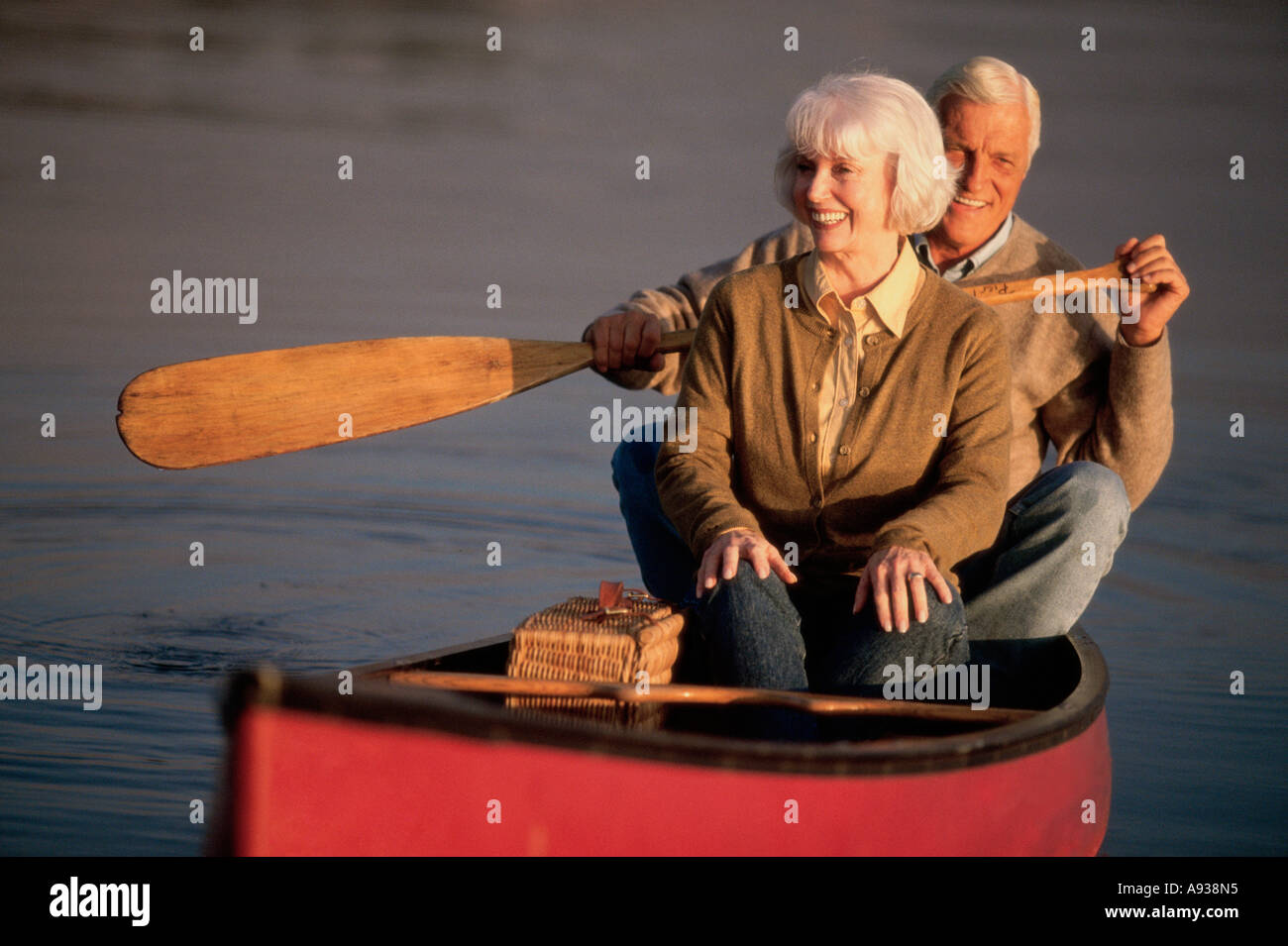 Senior couple rowing a boat Stock Photo