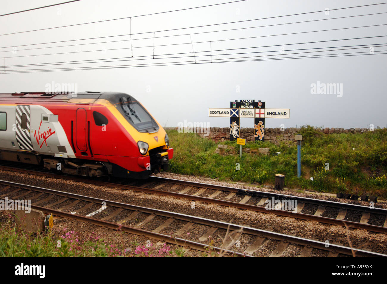 A Virgin Voyager High Speed Train speeds across the border from Scotland into England on a Virgin Cross Country express Stock Photo