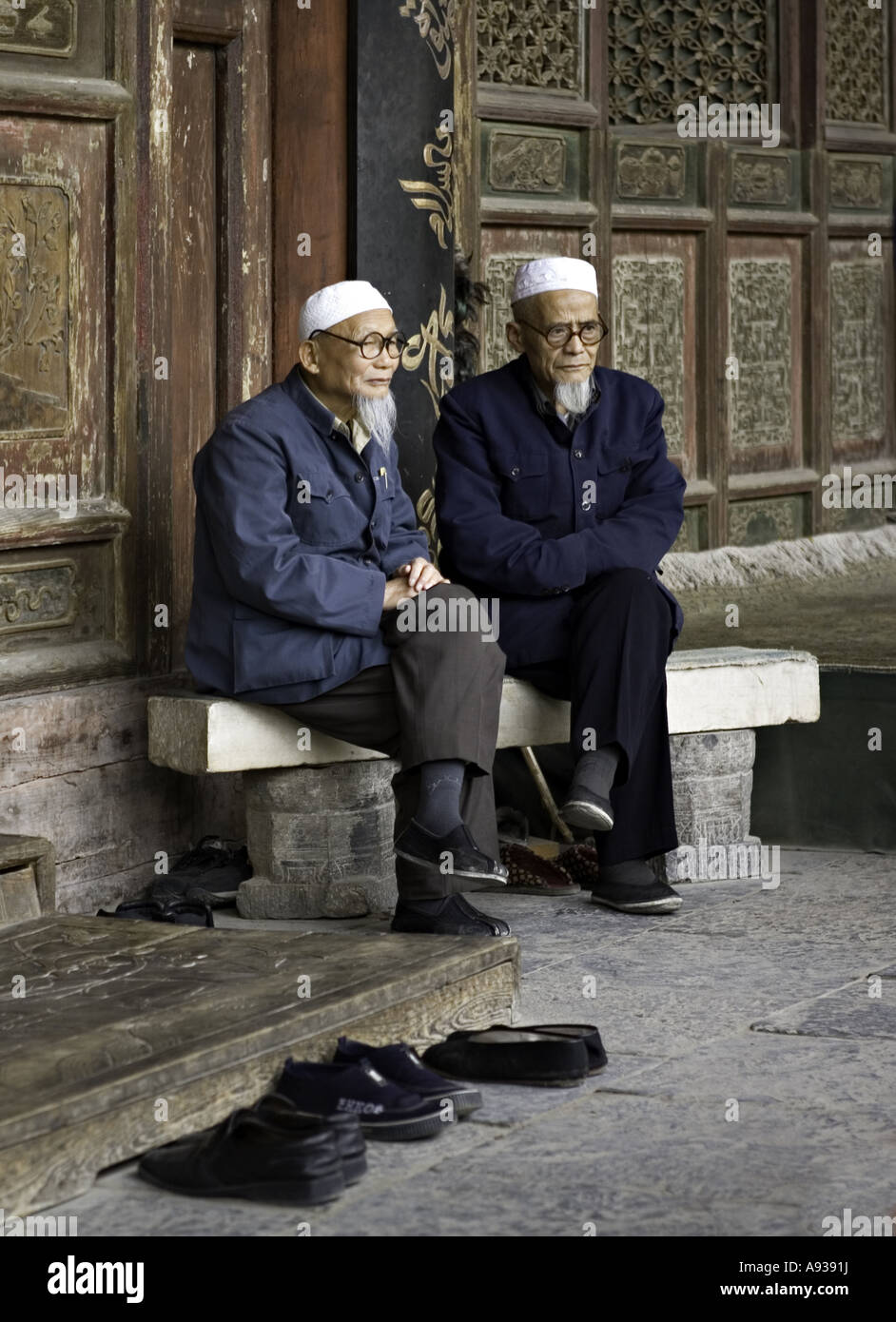 CHINA XI AN Elderly Chinese Muslim brothers sit outside the elaborately