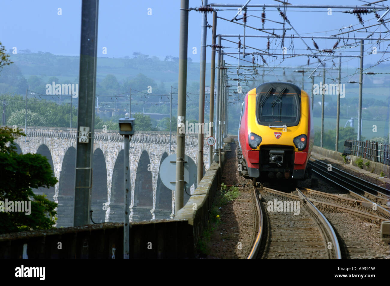 A Virgin Voyager High Speed Train speeds across the Royal Border Bridge at Berwick on Tweed Stock Photo