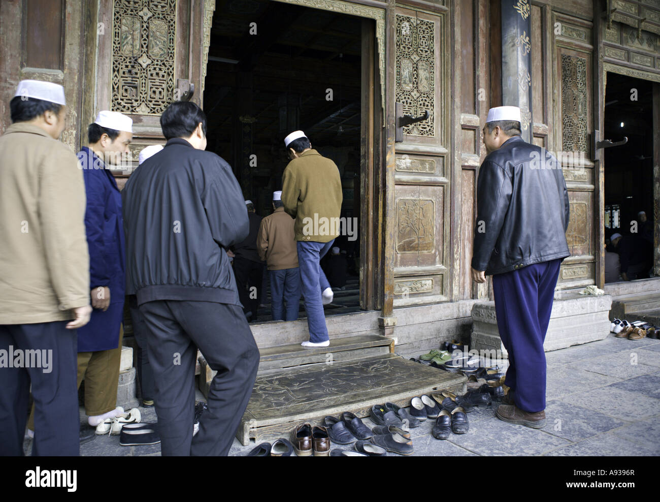 CHINA XI AN Devout Chinese Muslim men remove their shoes outside the elaborately carved and
