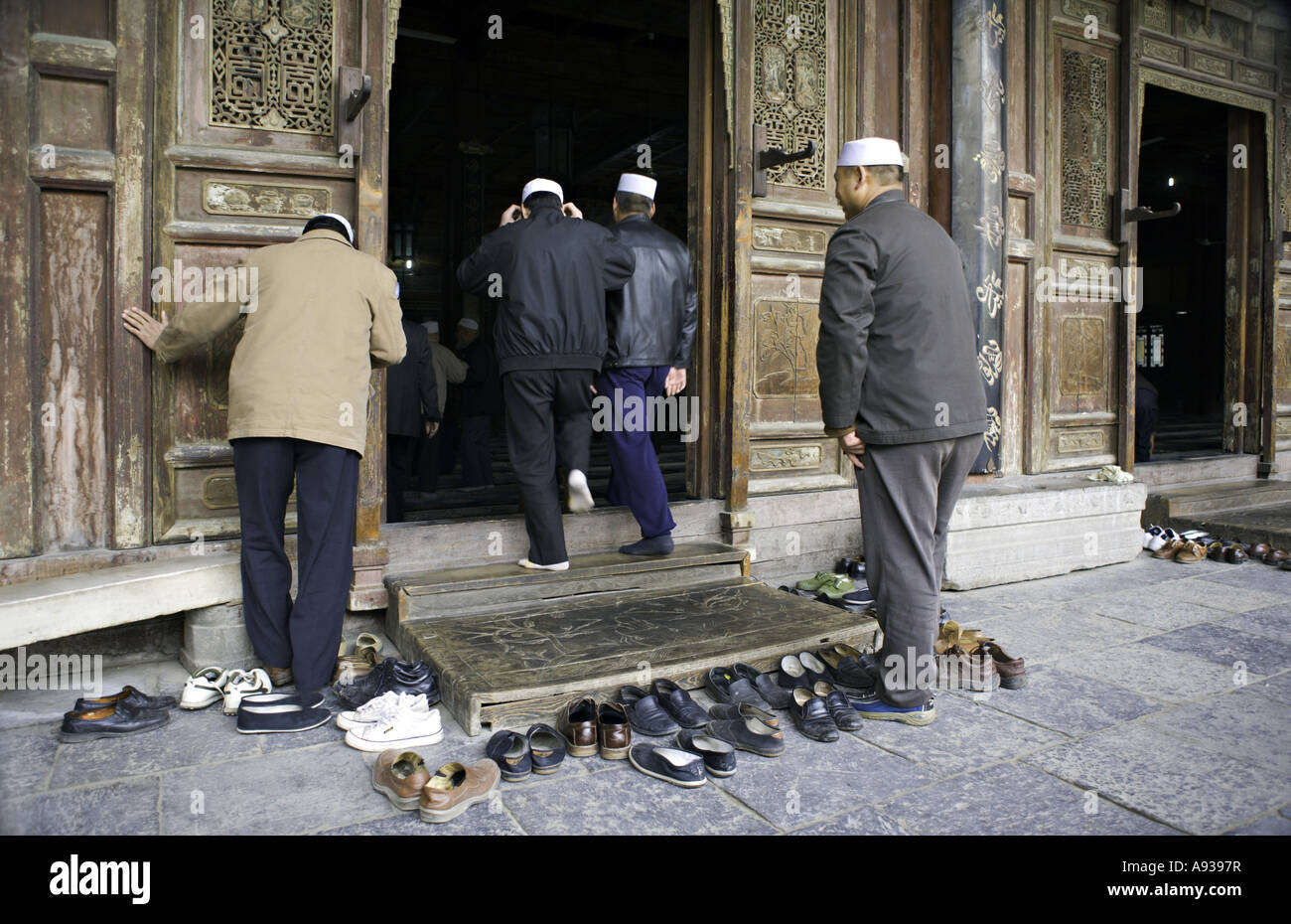 CHINA XI AN Devout Chinese Muslim men remove their shoes outside the elaborately carved and