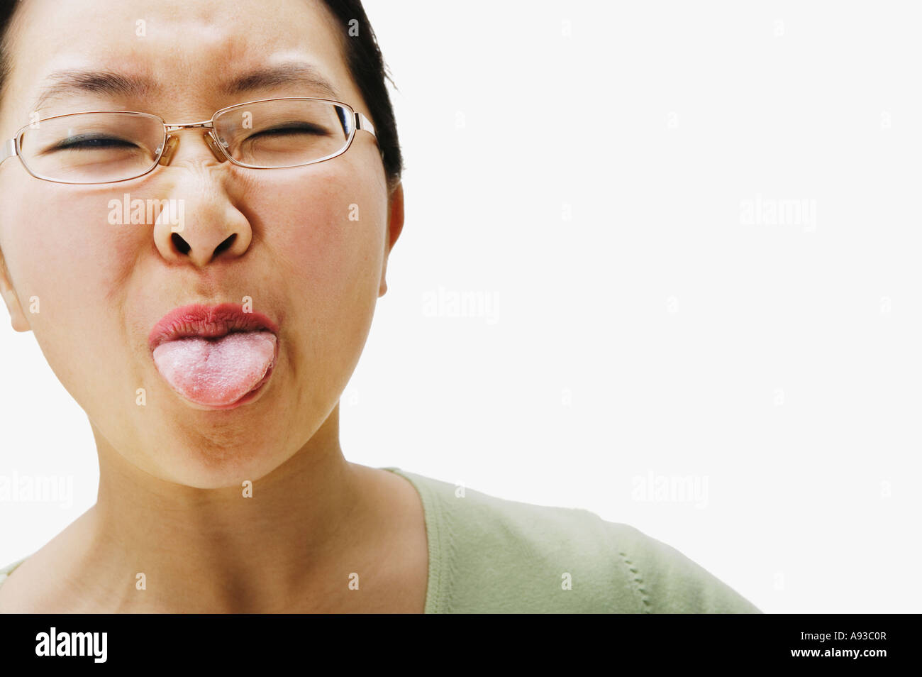 Portrait of Asian woman sticking out tongue Stock Photo