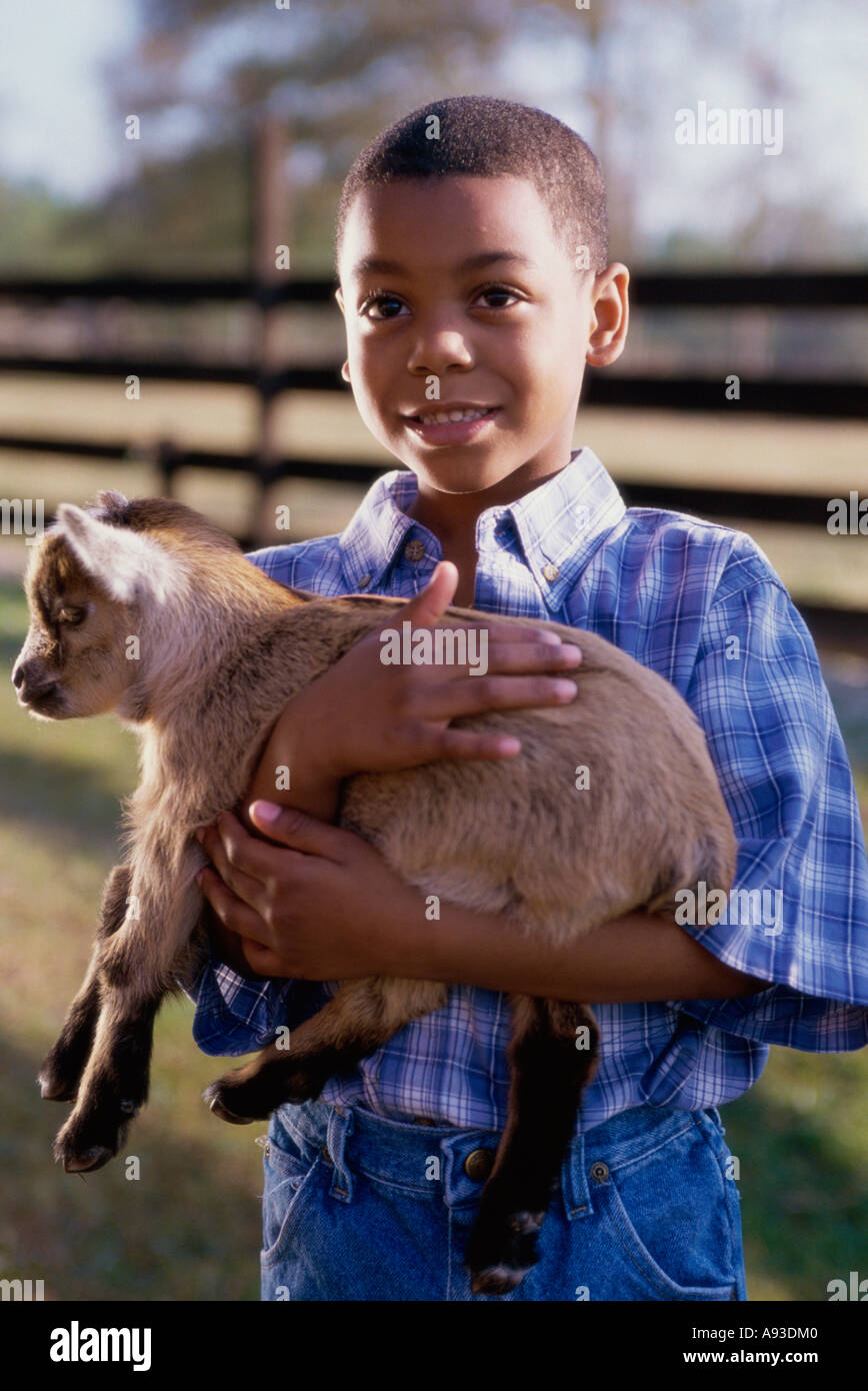 Close-up of a boy holding a lamb Stock Photo - Alamy
