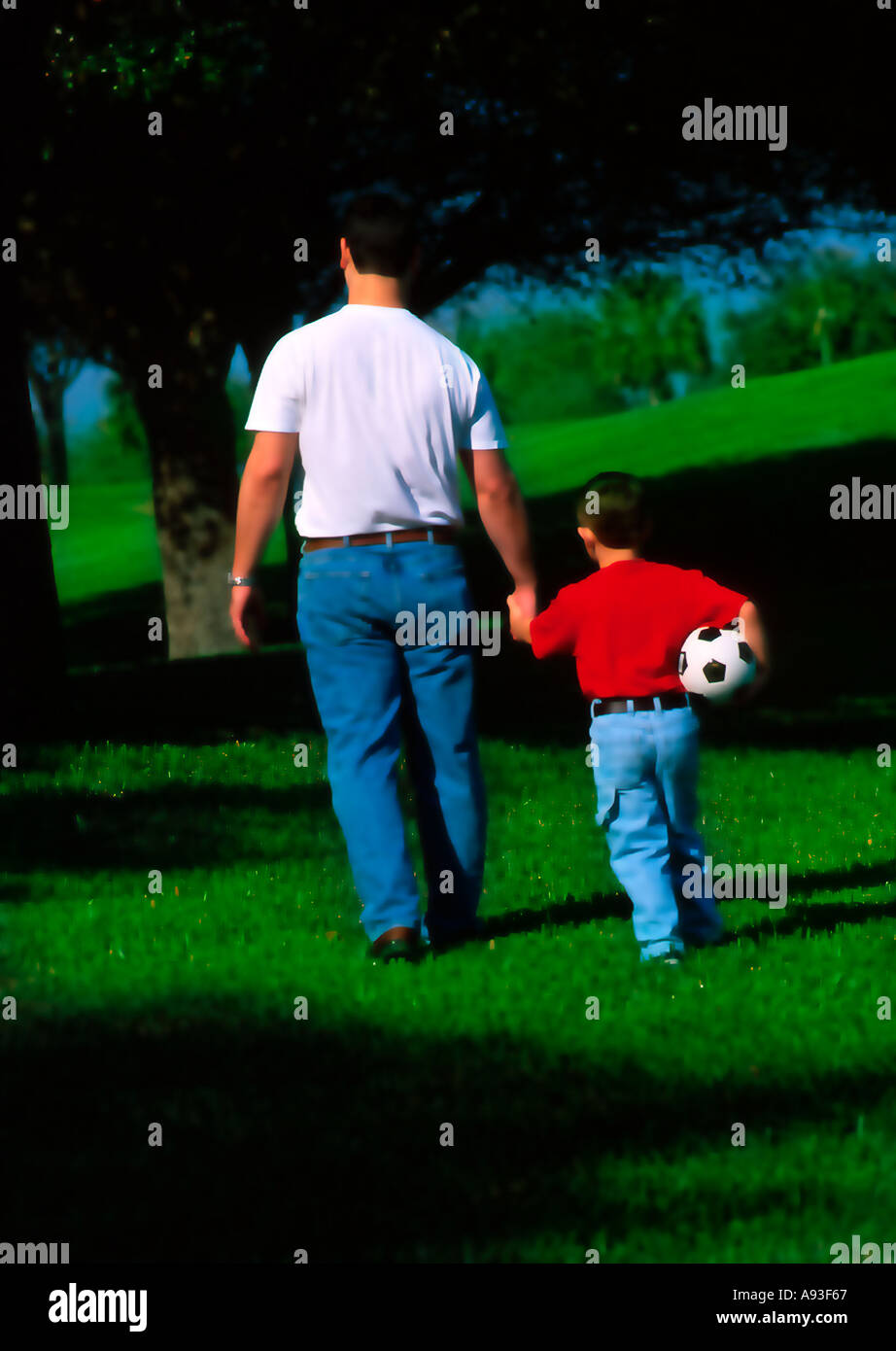 Father walking hand in hand with son Stock Photo - Alamy