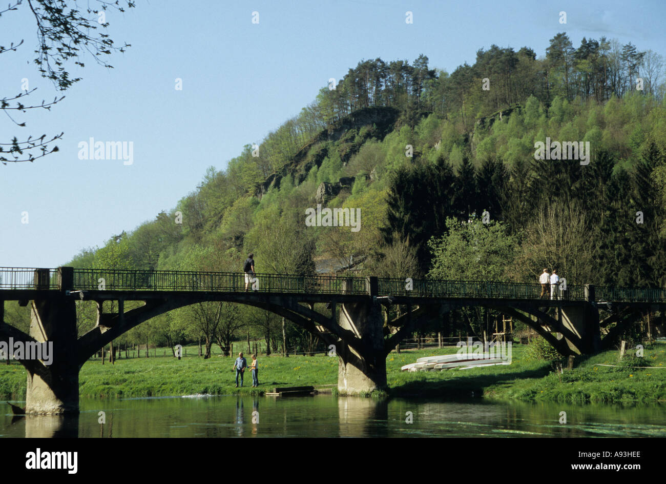 Walker on the bridge over the Semois to Frahan in the Belgian Ardennes Belgium Stock Photo