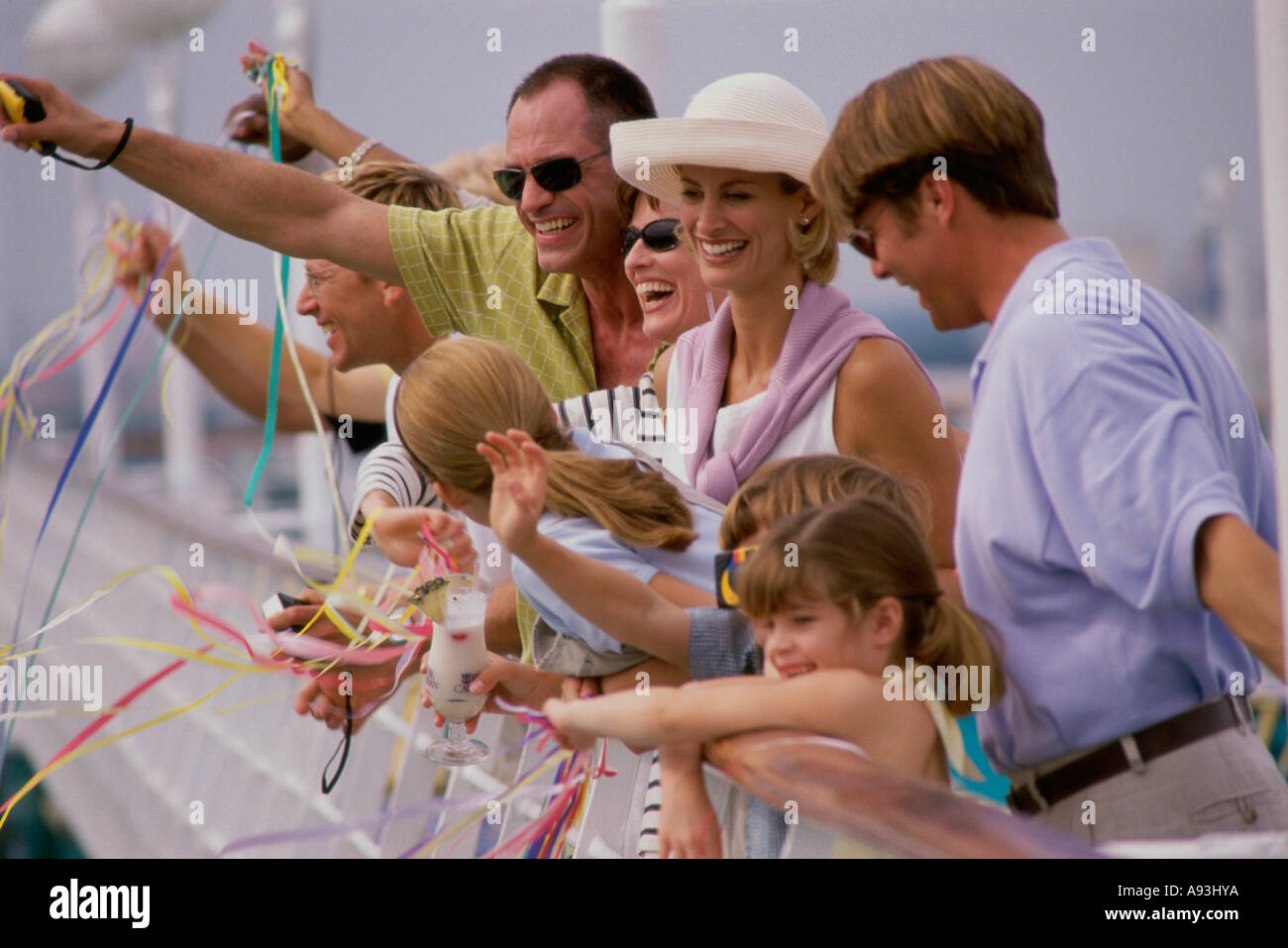 Tourists waving on the deck of a cruise ship Stock Photo