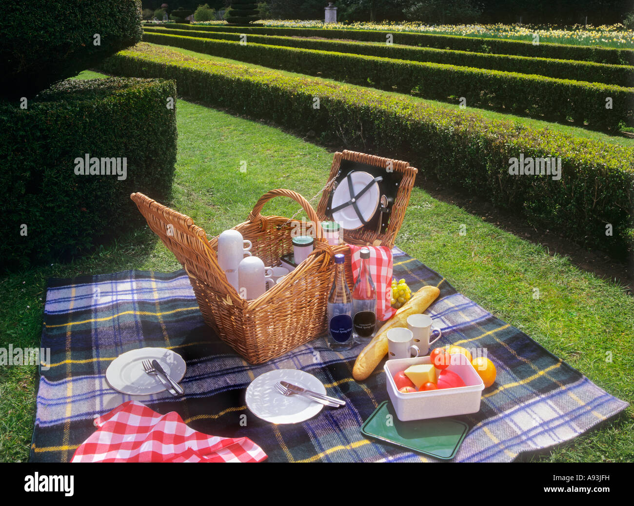Picnic basket and food laid out in an English stately home garden