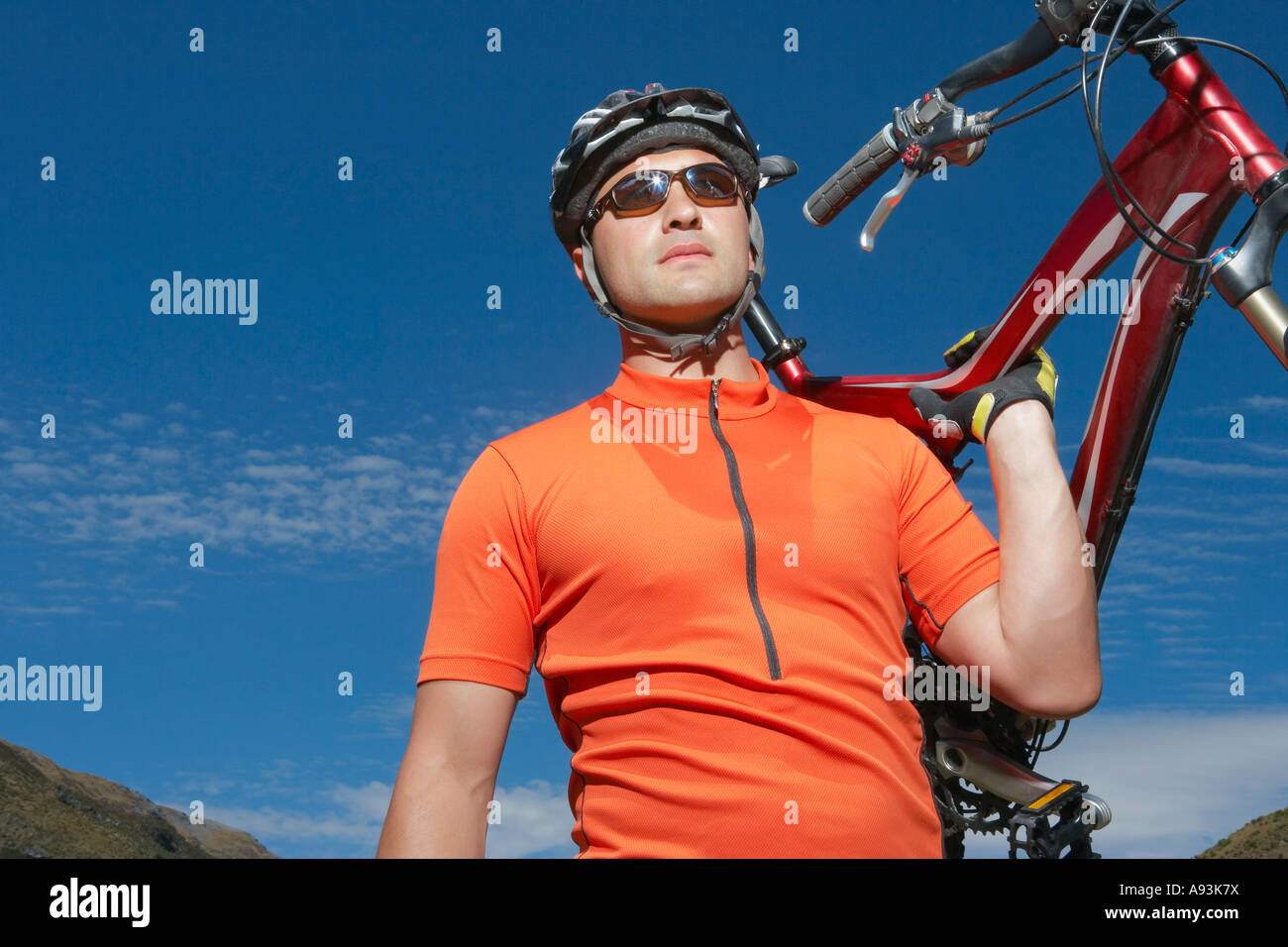 Cyclist carrying bike Stock Photo Alamy
