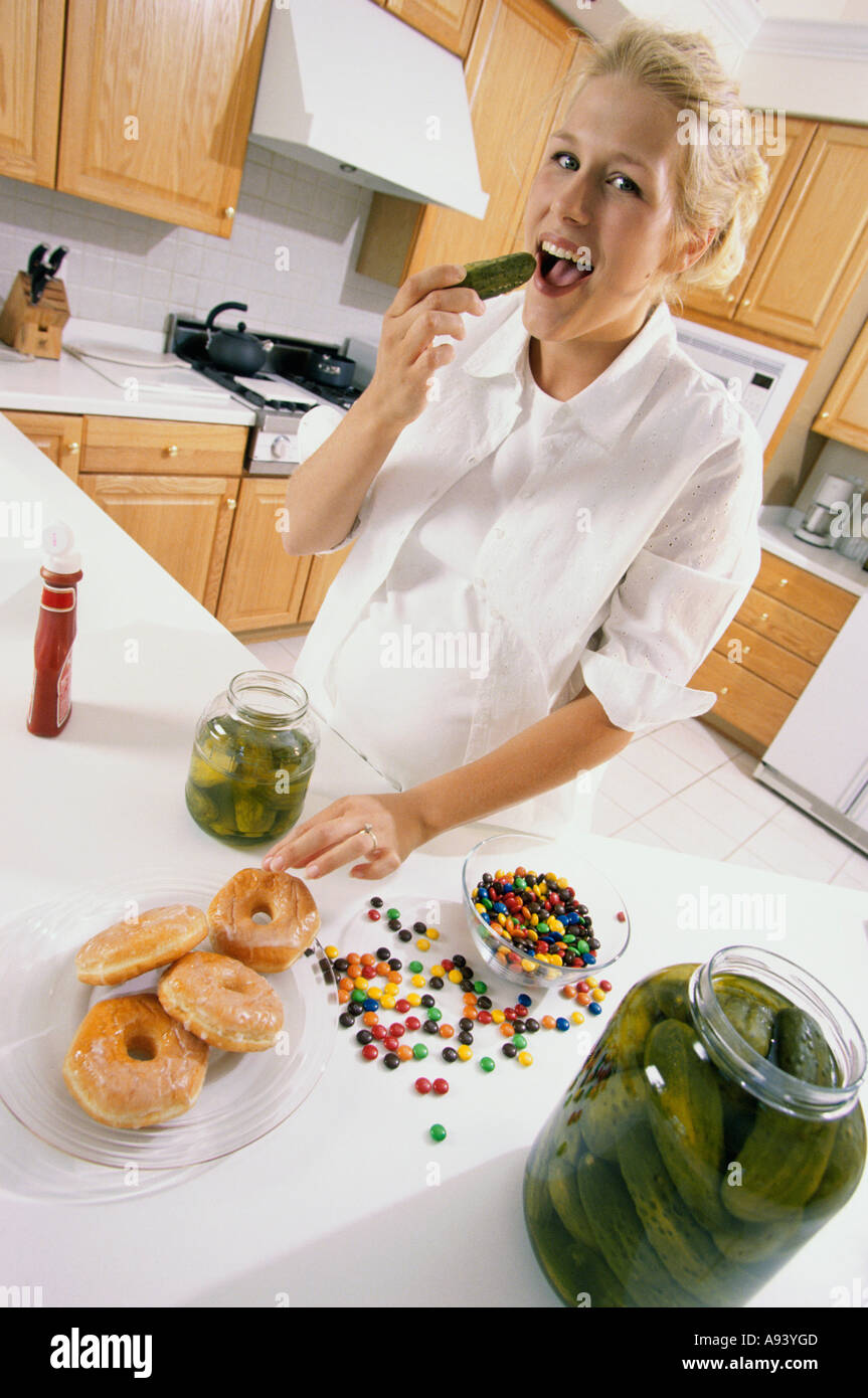 Portrait of a young pregnant woman eating pickles Stock Photo Alamy