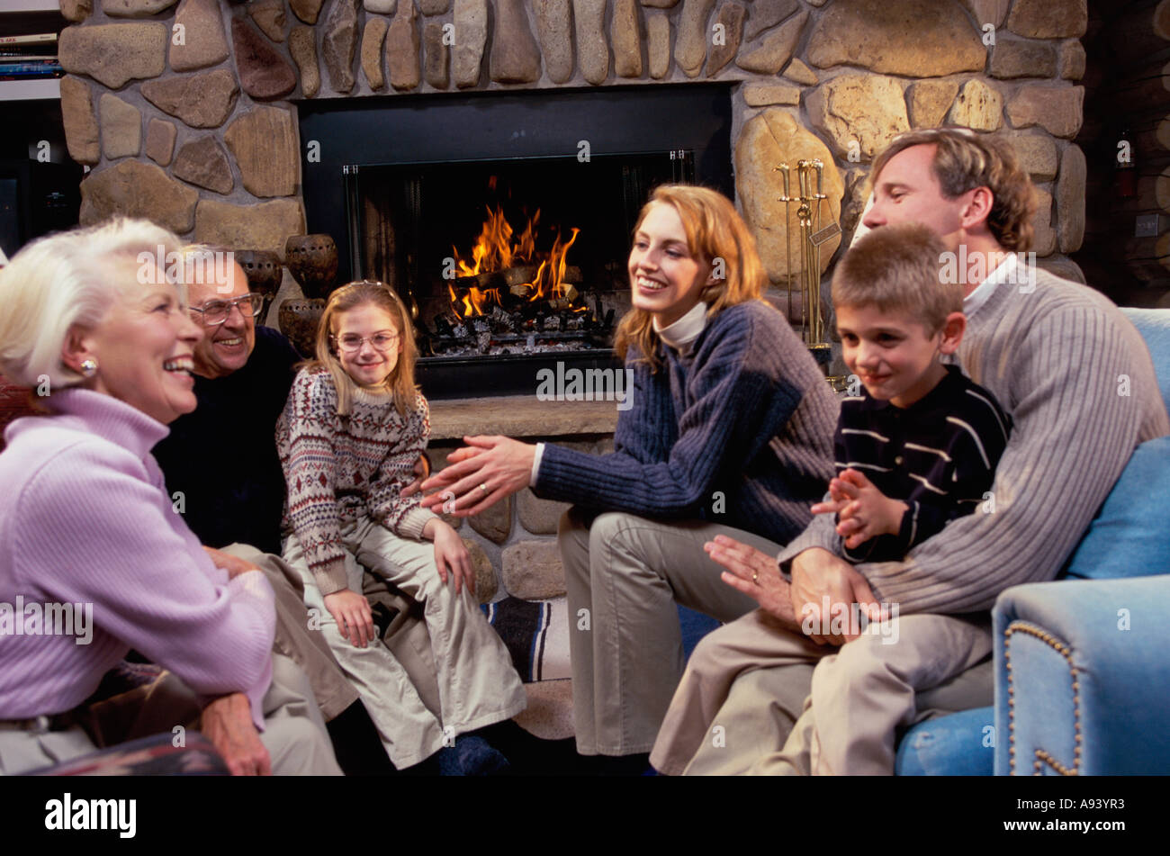 Group sitting in front fireplace hires stock photography and images