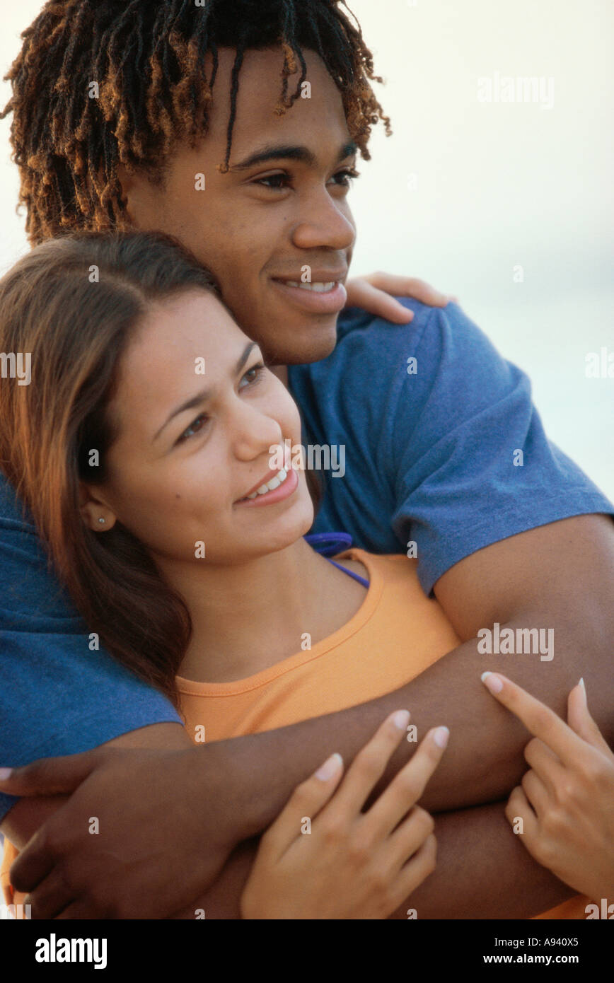 Close-up of a teenage boy embracing a teenage girl from behind Stock ...