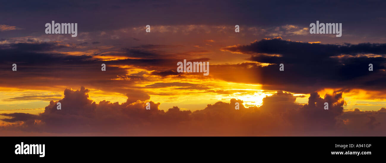 Panoramic view of an inspiring sunset and cloudscape in the evening sky ...