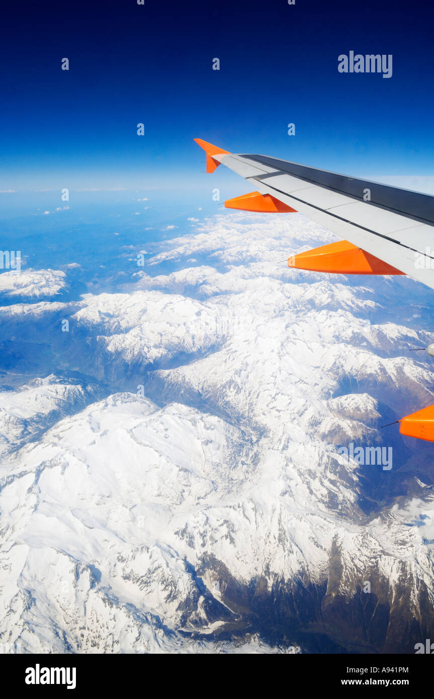 Aerial view of the Pyrenees Mountains in Andorra a passenger aeroplane with it's wing clearly visible. Stock Photo