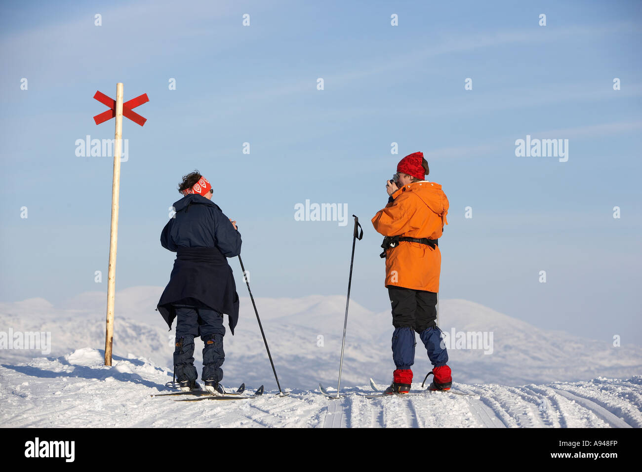 Skier taking photo, Bjorkliden, Lapland, Sweden Stock Photo