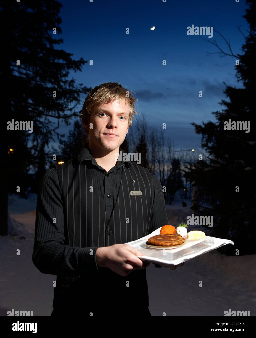 Waiter with food Homestead Restaurant, Jukkasjarvi, Kiruna, Lapland, Sweden Stock Photo