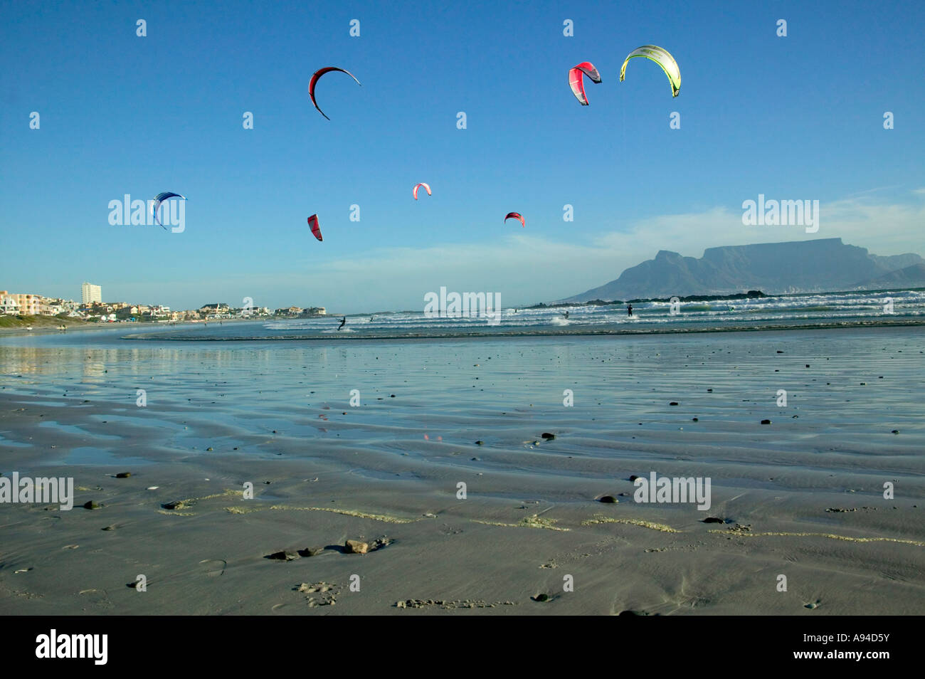 Kite surfers on one of Cape town beaches with Table Mountain in the background Bloubergstrand Cape Town Stock Photo