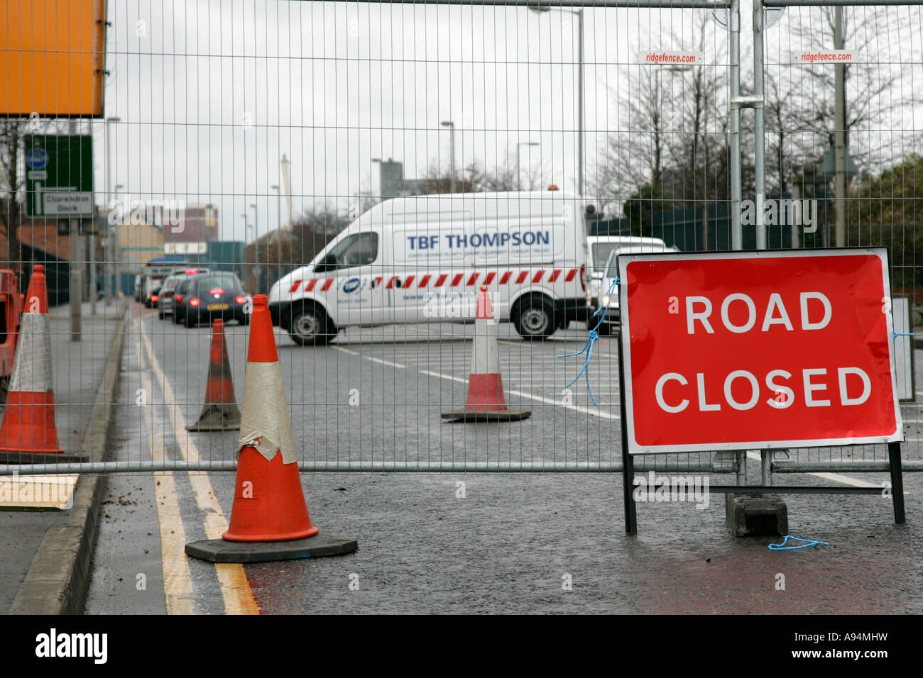 road closed sign fence traffic cones and traffic disruption due to road