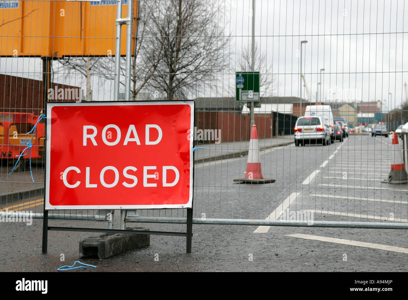 road closed sign fence traffic cones and traffic queued up in disruption due to road works belfast city centre Stock Photo