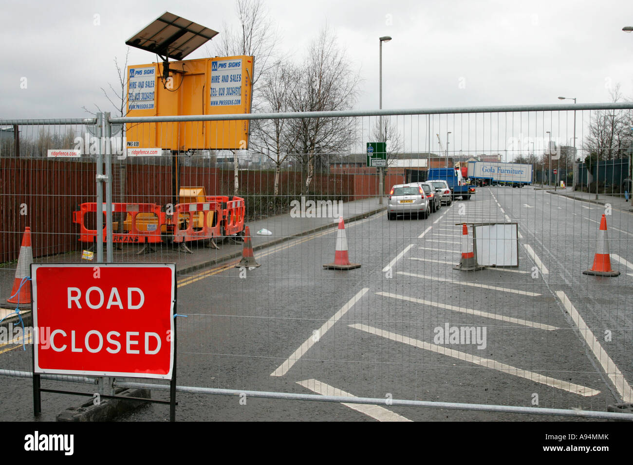 road closed sign fence traffic cones and traffic disruption due to road