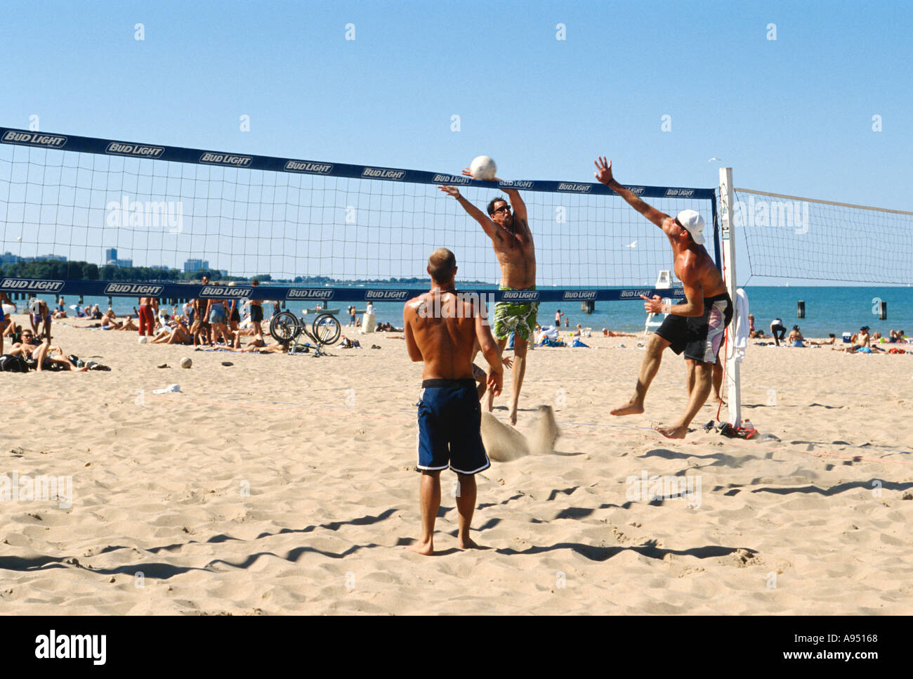 LAKEFRONT Chicago Illinois North Avenue beach volleyball game young adult males play sand Lake