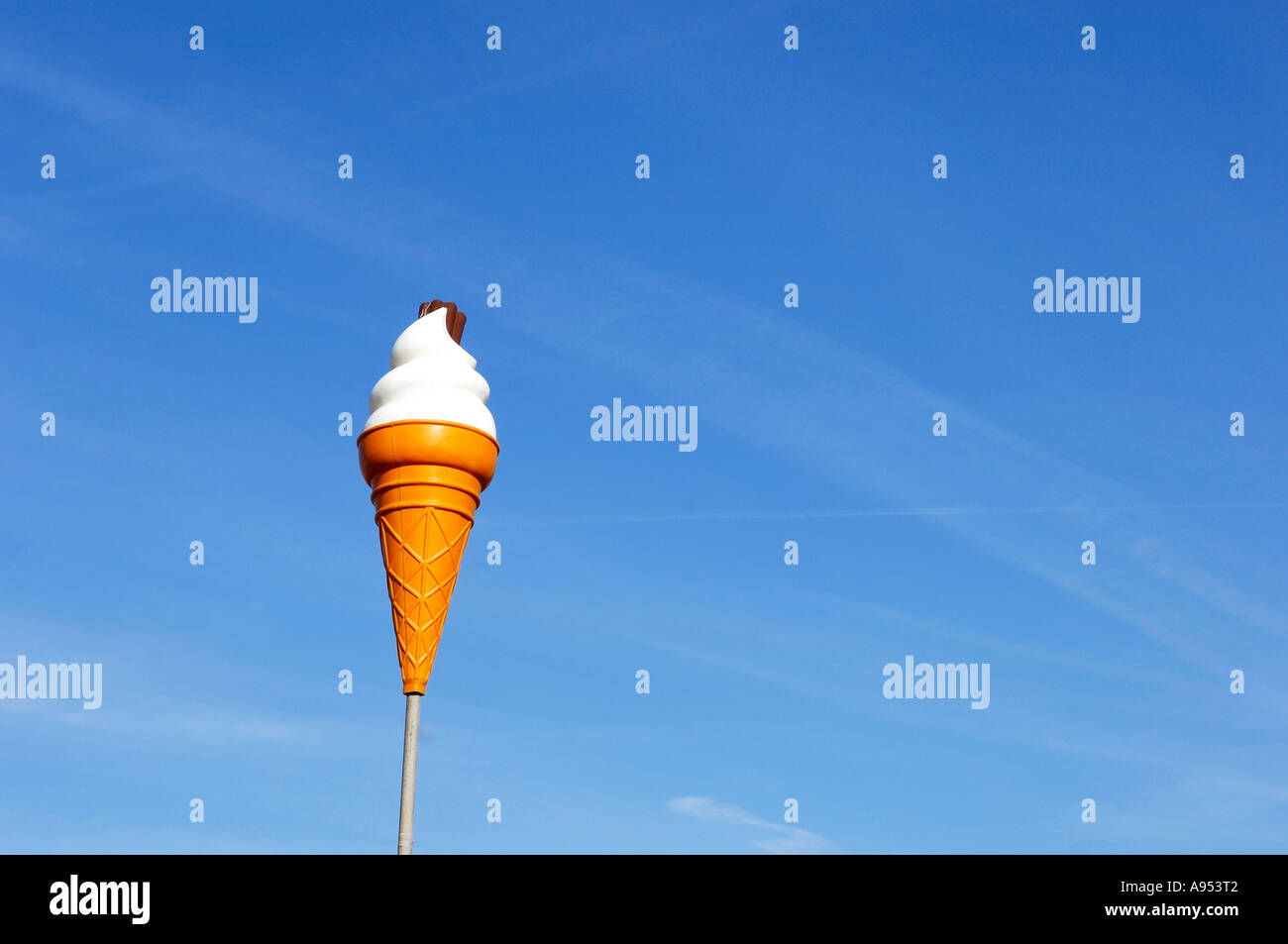 Plastic ice cream suspended in mid air against blue sky Stock Photo
