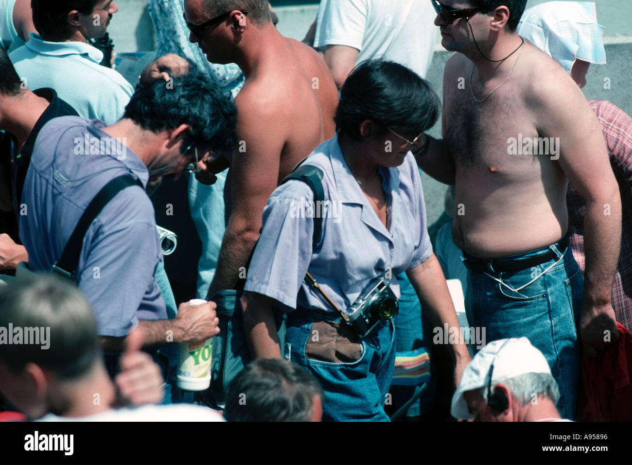 Crowd scene one woman has a Leica camera Stock Photo - Alamy