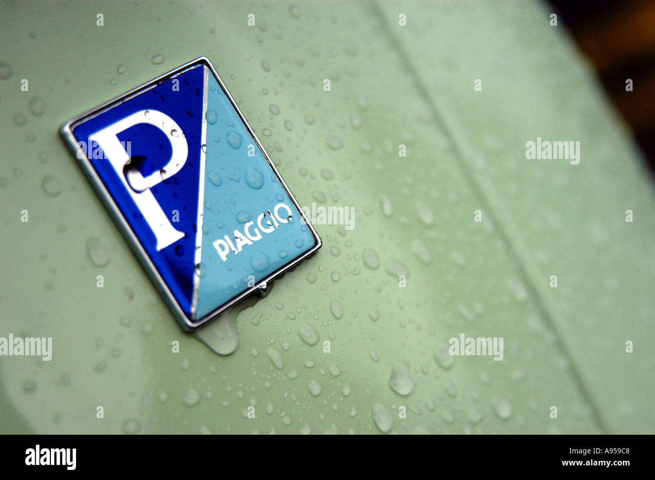 Detail of Piaggio sign on wet Vespa moped scooter, made by Piaggio ...