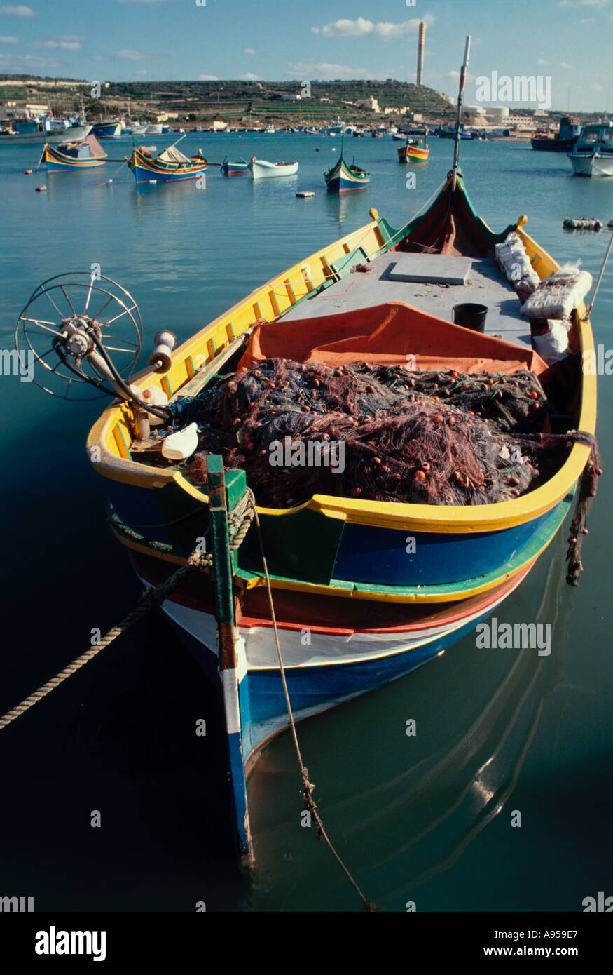 A luzzu inshore fishing vessel at Marsaxlokk harbour Malta Maltese Island Mediterranean Sea Europe Stock Photo