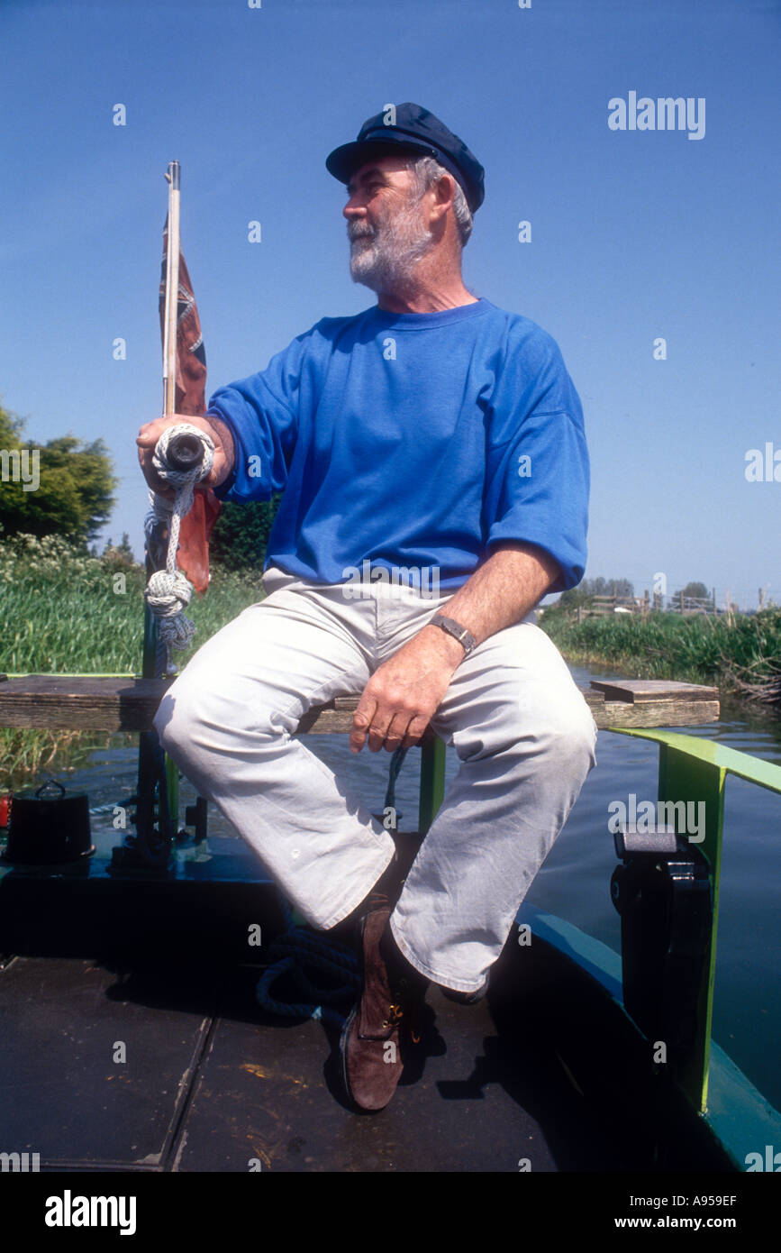 Man at the helm of a narrowboat hi-res stock photography and images - Alamy